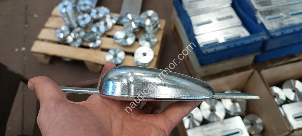 Nautical Armor founder hand holding a domed sacrificial anode during inspection.