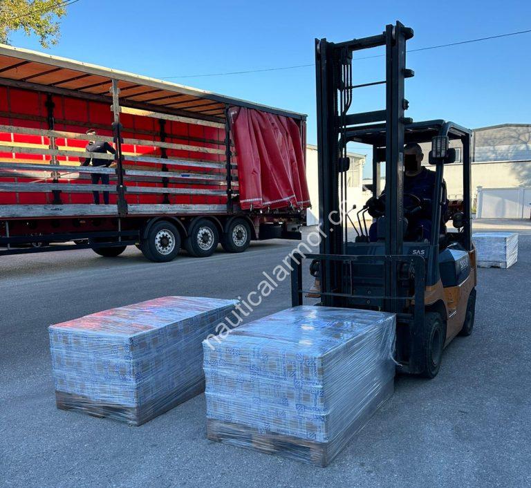 Forklift loading wrapped pallets of Nautical Armor sacrificial anodes onto a truck.