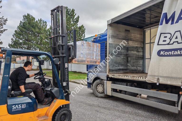 Nautical Armor forklift loading a wrapped pallet of boxed anodes into a truck