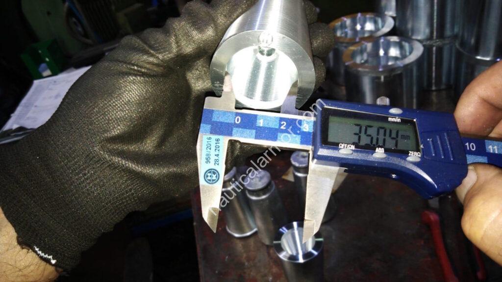 Digital caliper measuring a Nautical Armor propeller sacrificial anode during quality control.