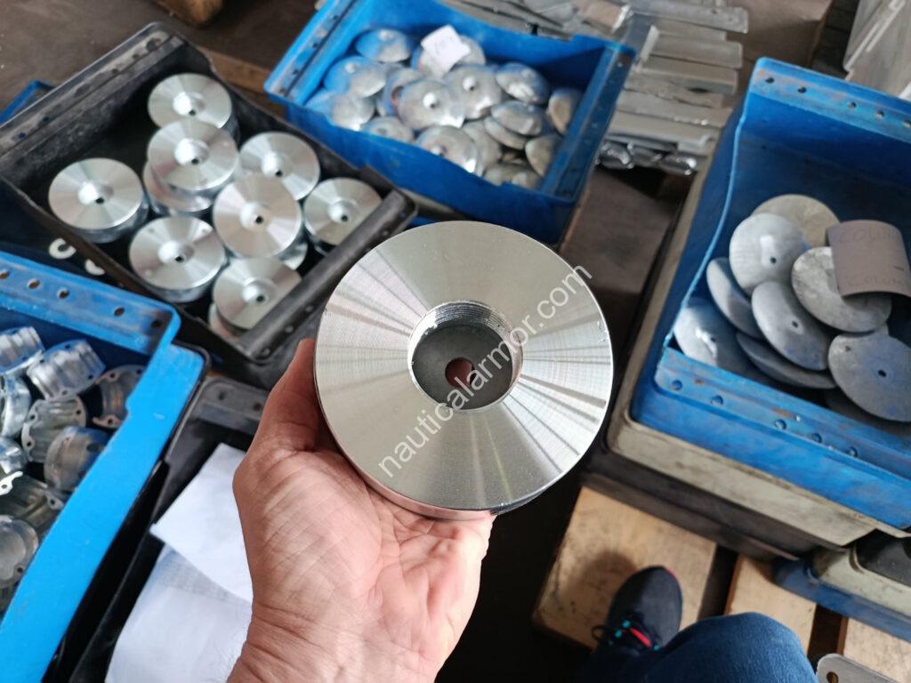Open boxes of Nautical Armor sacrificial anodes being prepared for a European customer order, including stern, rudder, pencil, and plate anodes.