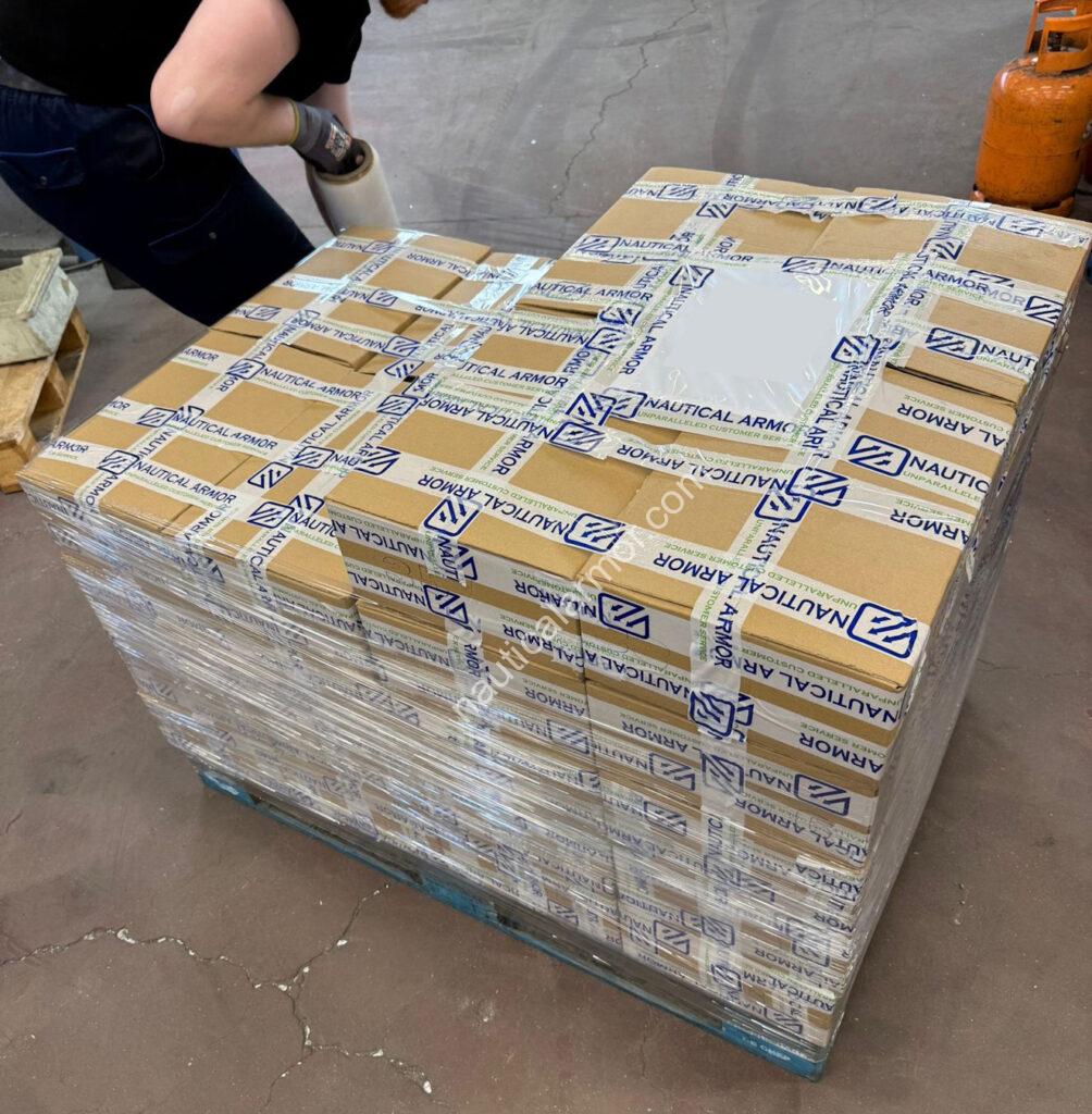 Wrapped pallet of Nautical Armor sacrificial anodes prepared for dispatch, sealed with Nautical Armor branded tape.