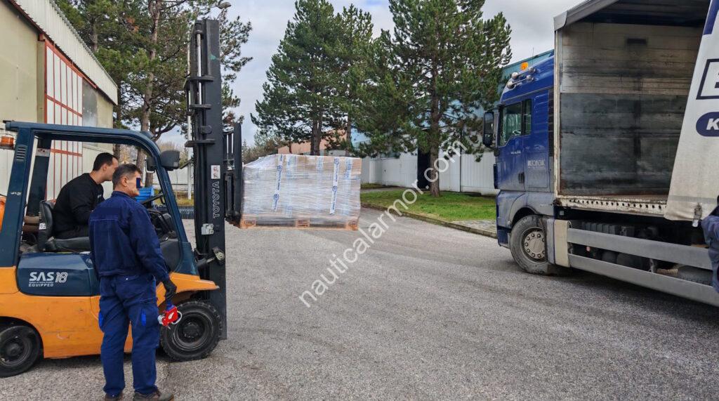 Wrapped Nautical Armor pallet of sacrificial anodes being loaded by forklift onto a truck for customer warehouse delivery